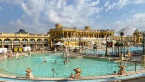 Széchenyi thermal bath outdoor pool with yellow Neo-Baroque building — terme Budapest