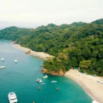 Aerial view of Costa Rica coastline with turquoise water, white sand beach, and lush rainforest — perfect for a Costa Rica itinerary