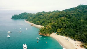 Aerial view of Costa Rica coastline with turquoise water, white sand beach, and lush rainforest — perfect for a Costa Rica itinerary